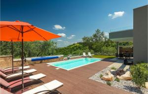 a swimming pool with an orange umbrella and chairs and a pool at Villa Primavera in Buje +52 photos