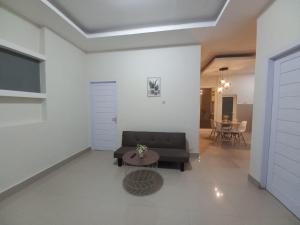 a living room with a couch and a table at NARAYA Guest House in Mataram