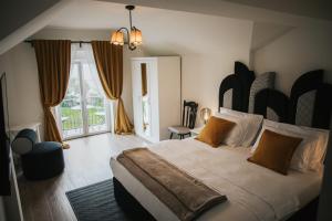 a bedroom with a large bed and a large window at Vila Slavonika in Slavonski Brod +72 photos