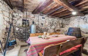 a dining room with a table and a wine barrel at Gorgeous Home In Moscenicka Draga in Martina