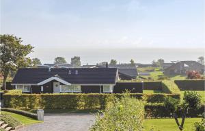 a house with the ocean in the background at Holiday Home Hvedemarken Sjølund Iii in Hejls +9 photos