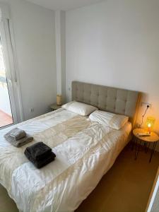 a bedroom with a large bed with a black bag on it at Casa Helen Las Terrazas de la Torre - Blue Sky Property in Murcia +28 photos