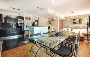 a living room with a glass table and chairs at 4 Bedroom Beautiful Home In Mougins in Mougins