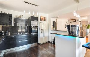 a kitchen with black cabinets and a counter top at 4 Bedroom Beautiful Home In Mougins in Mougins