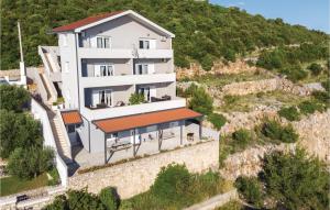 an aerial view of a building with a hill at One-Bedroom Apartment Klek With Sea View 05 in Klek