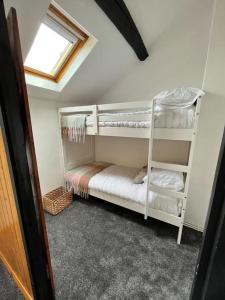 a bedroom with two bunk beds in a room at Love Lane Cottage Dolgellau in Dolgellau