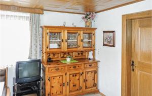 a wooden cabinet in a room with a tv at Ferienhaus In Ruhiger Lage in Kappl