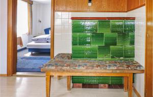 a room with a bench with green glass on the wall at Ferienhaus In Ruhiger Lage in Kappl