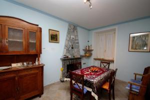 a dining room with a table and a fireplace at B&B Casa al Mulino in Cannero Riviera