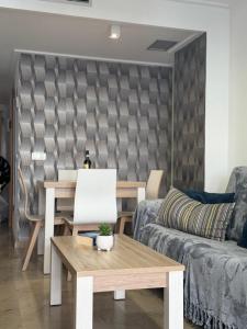 a living room with a table and a couch at Holiday Marina D'or in Oropesa del Mar