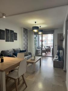 a living room with a table and a couch at Holiday Marina D'or in Oropesa del Mar