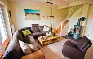 a living room with a couch and a wood stove at Gorgeous Home In Dagebüll With Sauna in Dagebüll