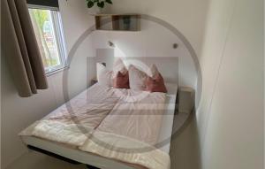 a bedroom with a bed in a room with a window at Waldcamping Am Brombachsee in Pleinfeld +9 photos