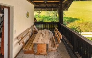 a porch with a wooden bench on a balcony at Ferienwohnung Klein St Paul in Eberstein