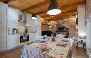 a kitchen and dining room with a table and chairs at Awesome Home In Glavina Donja in Donja Glavina