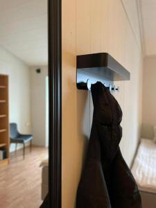 a pair of shoes hanging on a wall in a room at Haugesund City Apartments in Haugesund