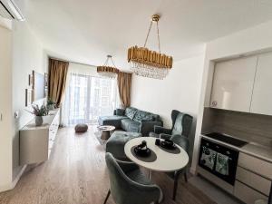 a living room with a couch and a table at Beldorado Apartments - Belgrade Waterfront Luxury Emerald Apartment 60m2 in Belgrade