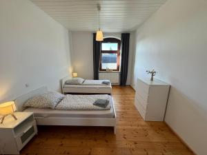 a bedroom with two beds and a window at Posthaus22 Wohnung OG in Salzgitter