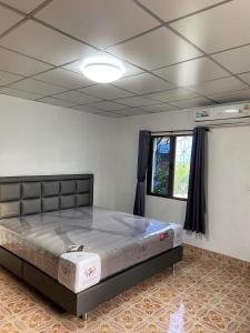 a bedroom with a large bed in a room at Wonder House in Hat Yai