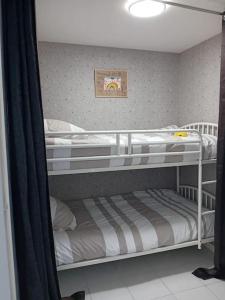 a couple of bunk beds in a room at Le Cœur des Océanes in Pornichet