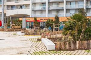 a building with a fence in a parking lot at Le Cœur des Océanes in Pornichet
