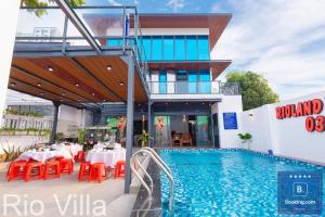 a restaurant with a pool in front of a building at Rio Villa 3 - Cách Biển 100 Met - Free Bida - Karaoke - 6 Phòng Ngủ - Gần Biển Đi Bộ in Vung Tau