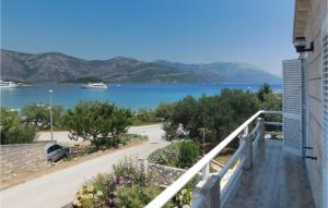 a balcony of a house with a view of a lake at Two-Bedroom Apartment In Racisce in Račišće