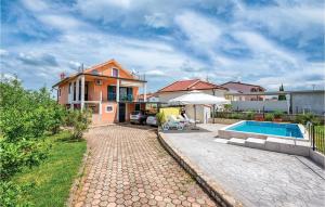 a home with a swimming pool and a house at 1 Bedroom Stunning Apartment In Kastel in Kaštel