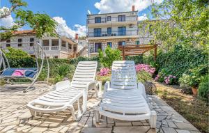 a group of lawn chairs sitting on a patio at Apartment Blace Bartulovici Iii in Blace
