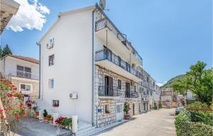 a white building with balconies on a street at Apartment Blace Bartulovici Iii in Blace +27 photos