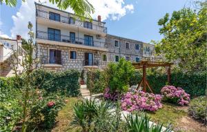 a building with a garden in front of it at Apartment Blace Bartulovici Iii in Blace