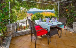 a table and chairs sitting on a patio at Gorgeous Apartment In Rabac With Wifi in Rabac