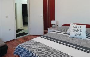 a bedroom with two beds with a salt and sea pillow at Two-Bedroom Apartment In Ston in Ston