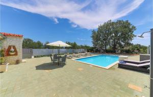 a swimming pool with a table and chairs and an umbrella at Cozy Apartment In Kastel Novi in Kastel Novi +23 photos