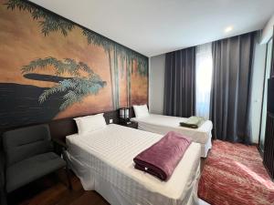 a hotel room with two beds and a chair at Lotus Wyndham Thanh Thủy in Phú Thọ +21 photos