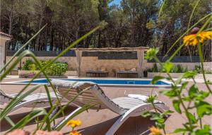 a pool with a lounge chair next to a swimming pool at 3 Bedroom Gorgeous Home In Jadrtovac in Jadrtovac