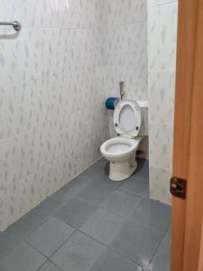 a bathroom with a toilet with the seat up at Khách Sạn Nam Nguyên in Buon Ma Thuot