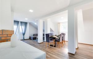 a dining room and living room with a table and chairs at Awesome Home In Pregrada With Wi-Fi in Pregrada