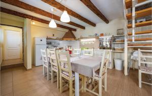 a kitchen with a table and chairs in a room at Holiday Home Tinjan 56 in Tinjan