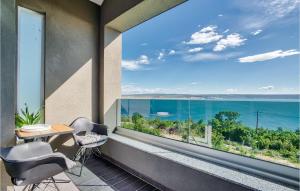 a balcony with a table and chairs and a large window at Villa Amy in Zadar