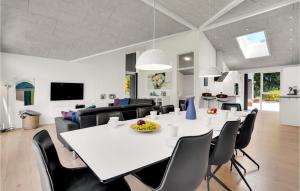 a dining room and living room with a white table and chairs at 4 Bedroom Cozy Home In Spøttrup in Spottrup