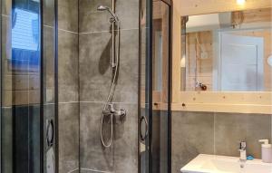 a shower with a glass door in a bathroom at Awesome Home In Jantar With Sauna in Jantar +4 photos