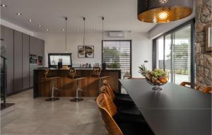 a kitchen and dining room with a table and chairs at Stunning Home In Crikvenica in Crikvenica