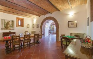 a dining room with tables and chairs and an archway at Villa Murlo in Sovignano