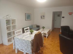a living room with a table and a couch at Roberto Furadouro Beach House in Furadouro