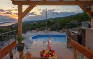 a table with a bowl of fruit and a bottle of wine at Villa Ancora in Jadranovo +35 photos
