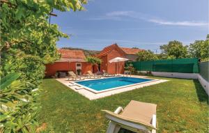 a backyard with a swimming pool with chairs and a house at Holiday Home Kresevo 23 in Kreševo