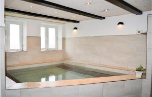 a pool of water in a large room with two windows at Gorgeous Home In Skjern in Lem
