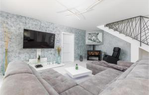 a living room with a couch and a tv at 4 Bedroom Beautiful Home In Jursici in Juršići