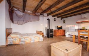 a bedroom with a bed and a table in a room at Holiday Home Jezera With A Fireplace 04 in Jezera